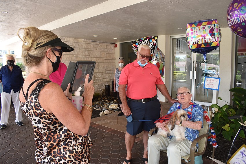 Judy Endean snaps a photo of husband David with Jimmy Loftis and the Endeans' dog Gidget.