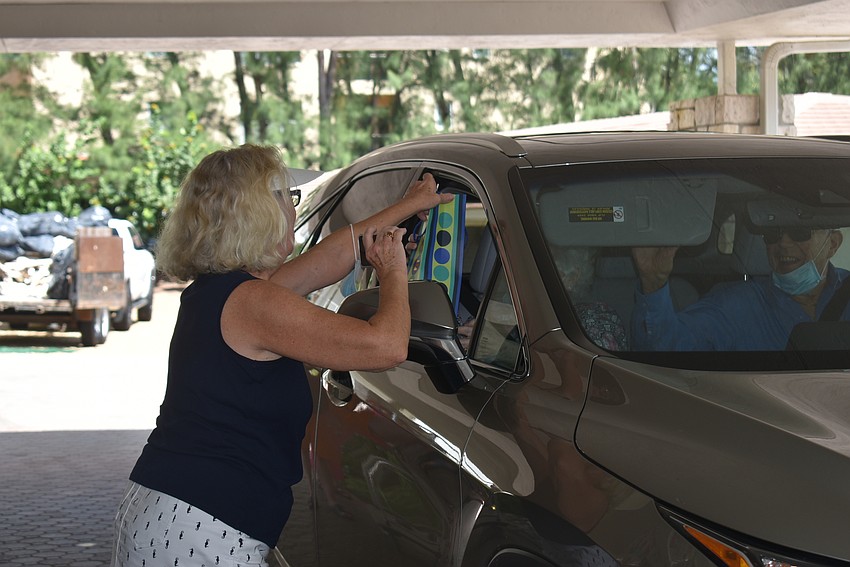 Patty Poole grabs a gift from a drive-by well-wisher.