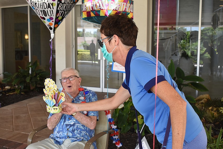 Jimmy Loftis accepts a singing card from Mara Bell.