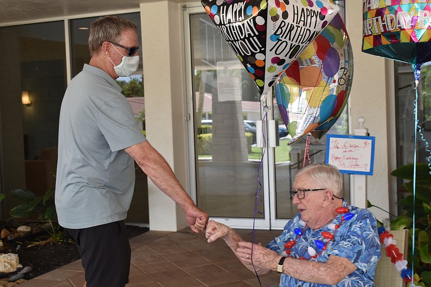 Eric Bell and Jimmy Loftis bump fists instead of shaking hands.