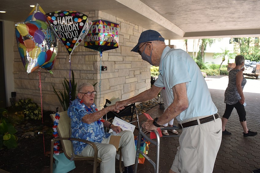 Jimmy Loftis bumps fists with longtime friend Joe Callahan.