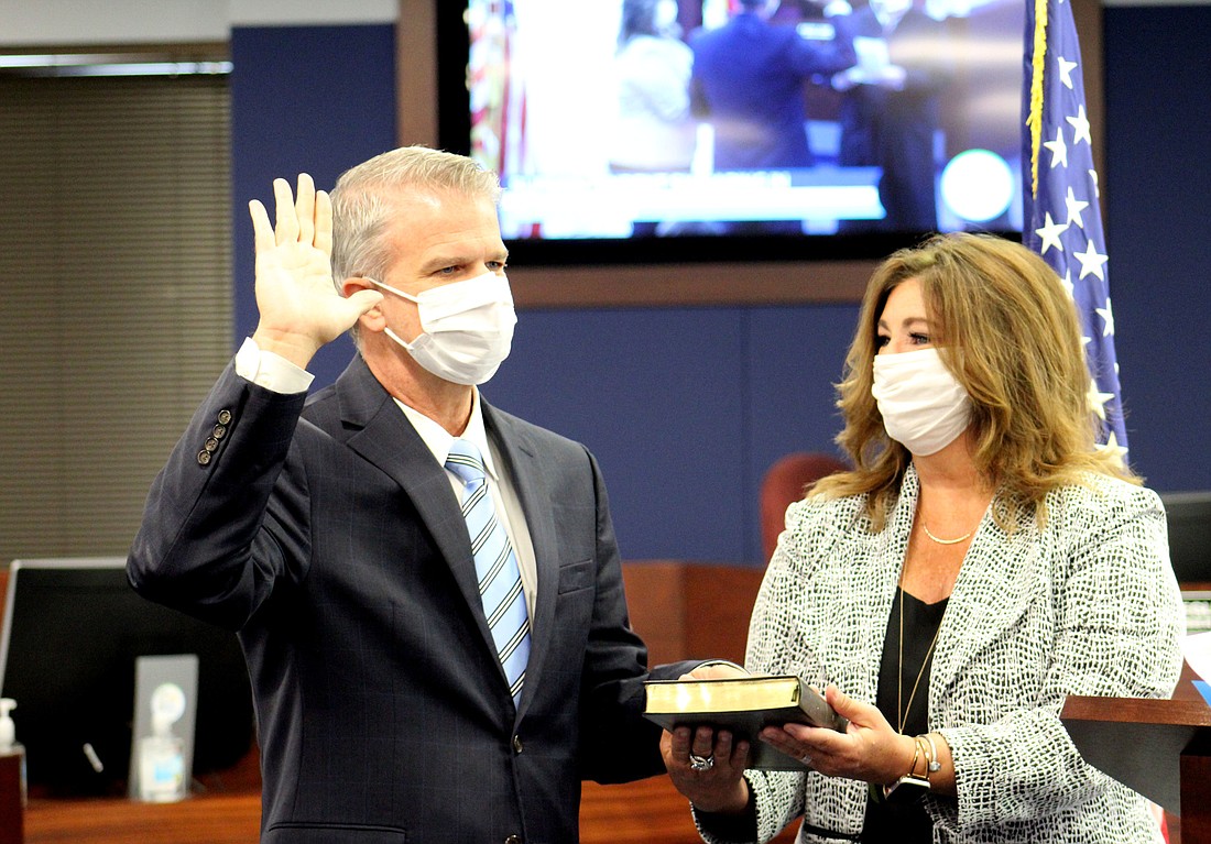 Brennan Asplen is sworn in as the new Sarasota County Schools superintendent while his wife Mari Ellen Asplen looks on.