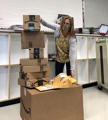 Katie Kandel, a fourth grade teacher at Freedom Elementary School, is shocked to receive so many donations. She received 11 packages just two days after posting her list to the Adopt a Manatee County Teacher page. Courtesy photo.