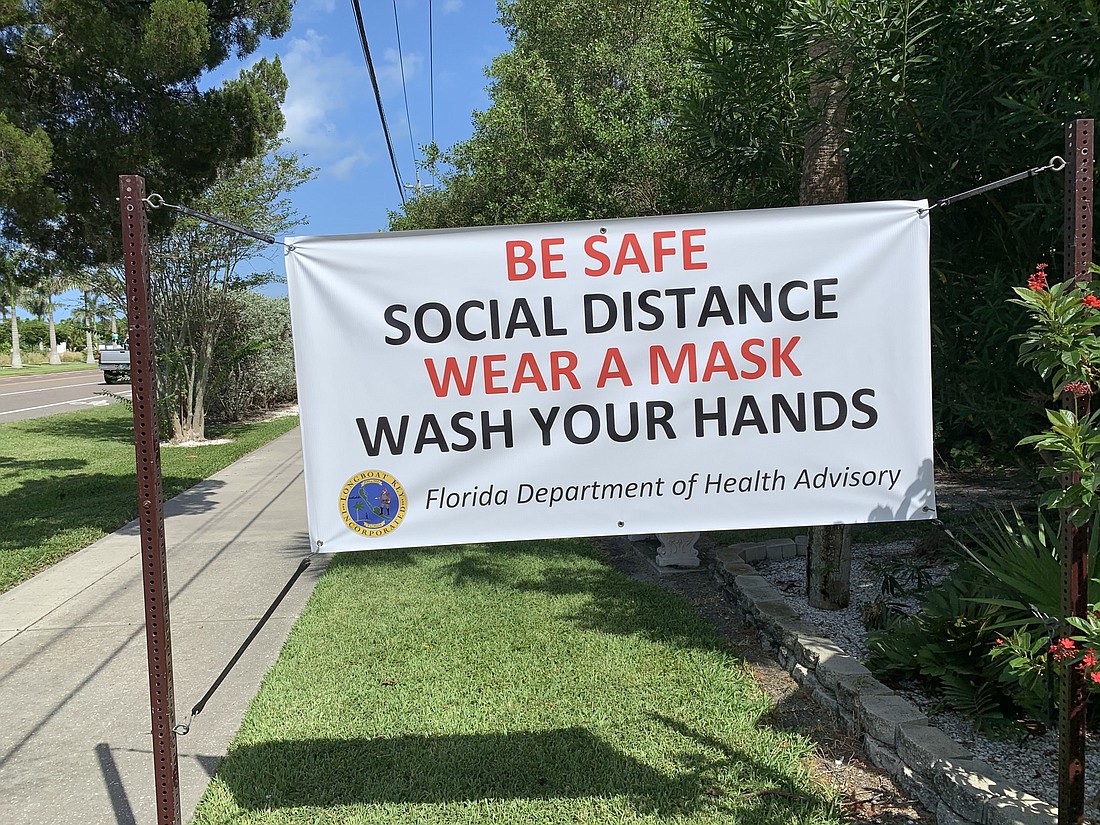 The town of Longboat Key has posted several of these "wear a mask" signs throughout the island.