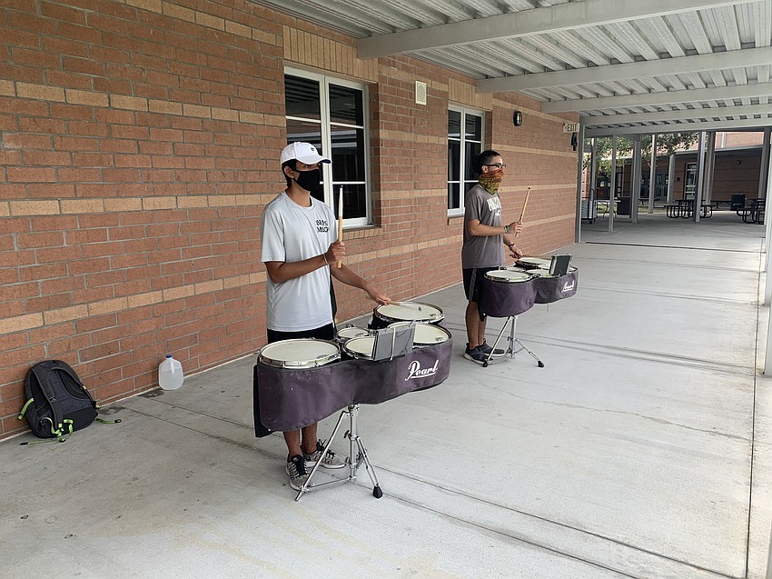 Seniors Gabriel Garcia and Jonathan Mesquita practice social distancing while rehearsing. Courtesy photo.