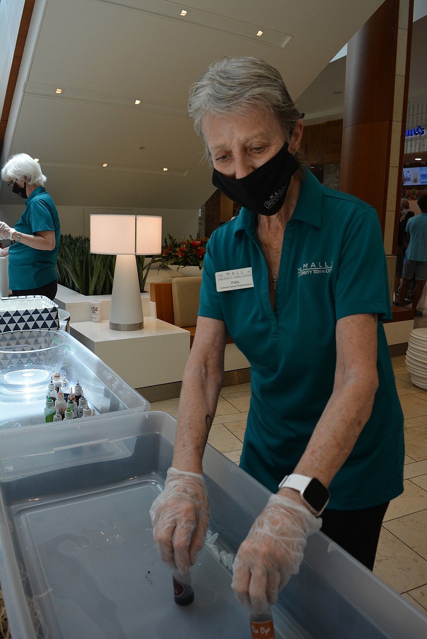 The Mall at UTC customer service representative Patty Hasson helps with dying face masks.