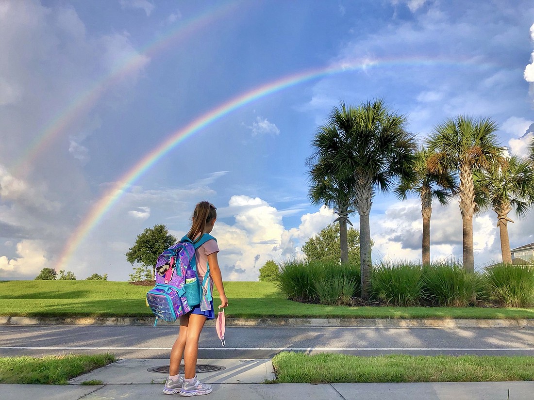 Sophie Niedzielski, a second grader at B.D. Gullett Elementary School, sees a double rainbow on her way to her first day of school. Niedzielski says the double rainbow is a sign of good luck. Photo by Dagmara Niedzielski.