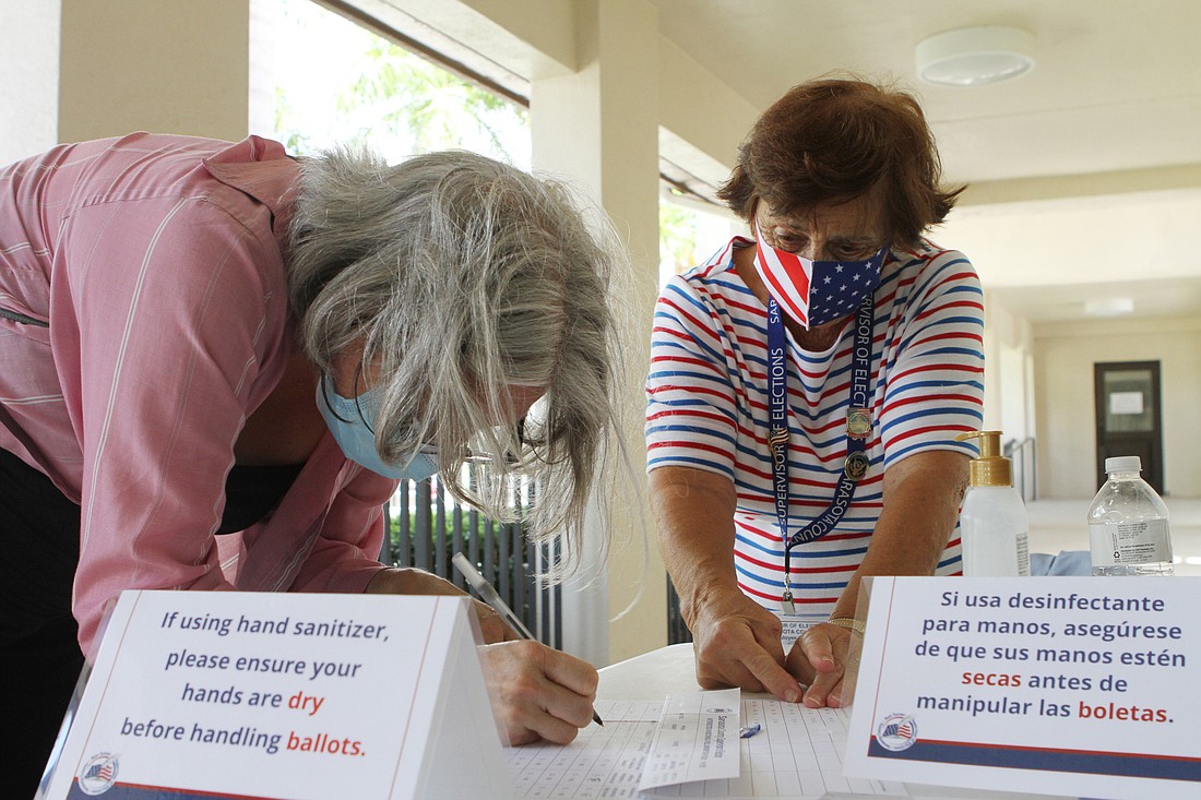  Deputy Election Official Lucille Cirrintano helped Cheryl Stade fill out information at the First Presbytarian Church polling location at 2050 Oak St.