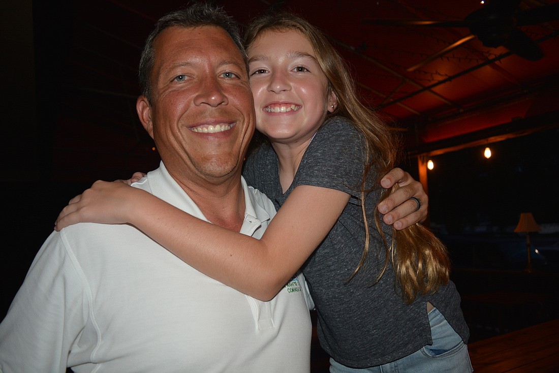 Eleven-year-old Olivia Kruse hugs her dad, George Kruse, after he wins the Republican nomination. "I&#39;m really proud of him," she said. "There was a lot of sign waving."