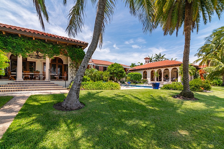 A courtyard and Romanesque swimming pool are located in the back of the home.