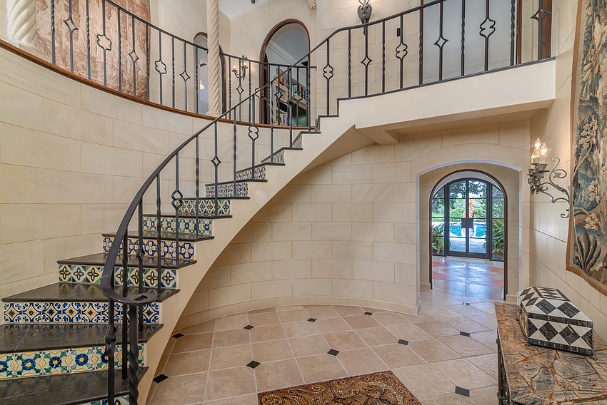 A large entryway features mosaic tile stairs.