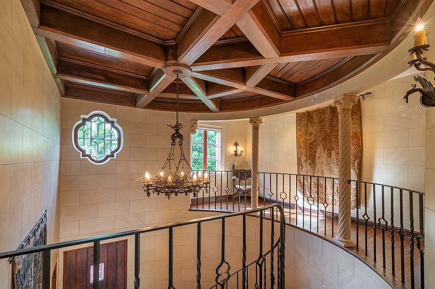 A walkway overlooks the basement floor of the home.