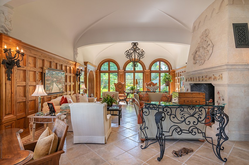 A living room boasts a large fireplace.