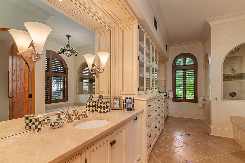 One of the bathrooms features built-in cabinets and space to put on makeup.