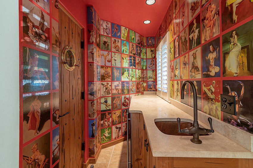 A bar room just off the billiard room features antique wall paper.
