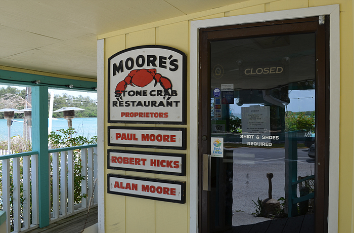 Moore's Stone Crab Restaurant announced its closure Wednesday via signs on the doors Wednesday.