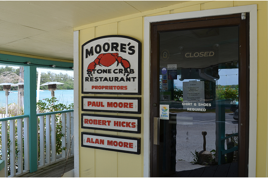 Moore's Stone Crab Restaurant announced its closure Wednesday via signs on the doors Wednesday.