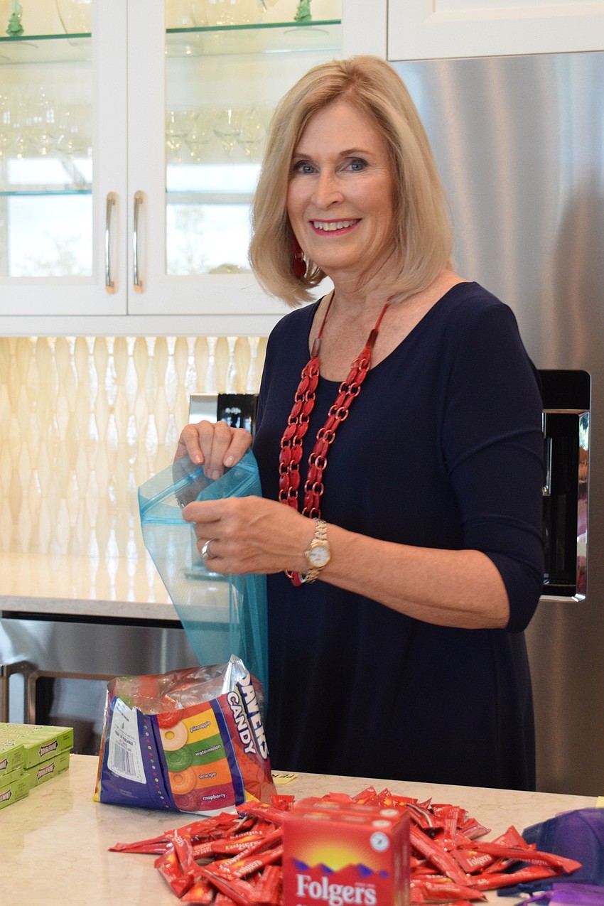 River Club's Carole Sullivan fills gift bags with snacks for Manatee County Sheriff's Office deputies. Sullivan wanted to show support for local law enforcement.