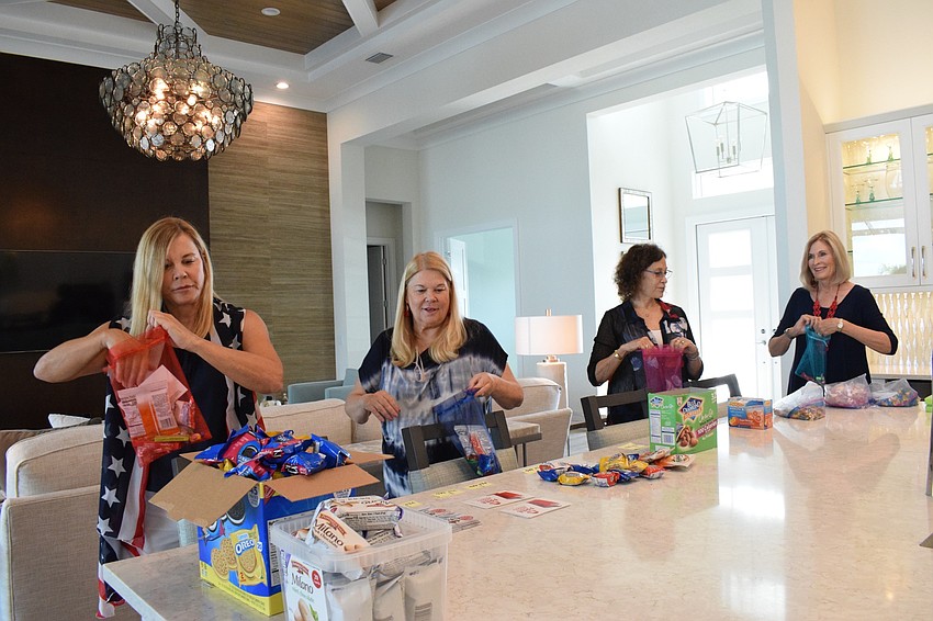Pat Ruggero, Maureen Rosin, Virginia Craig and Carole Sullivan form an assembly to fill 350 bags to give to deputies of the Manatee County Sheriff's Office.