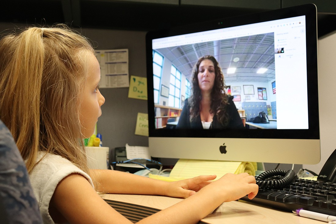 First-grader Tyler Sweeting tests out the school&#39;s adaptive learning program with teacher Leslie Ruben. Courtesy Photo
