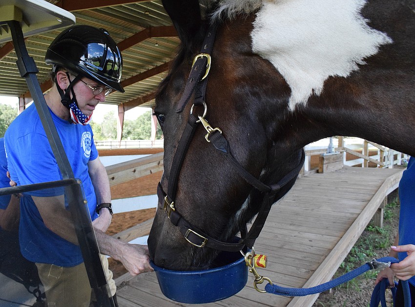 Dan Mohl gives Gallagher treats. Mohl has been riding horses since he was 12 years old and hopes to compete at the paralympics some day.