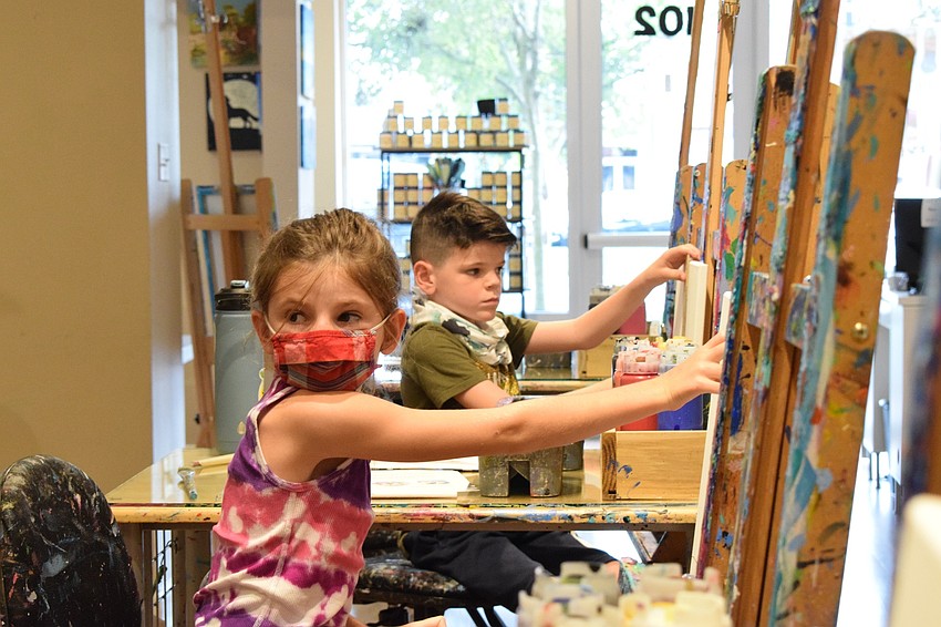 Adriana Buchanan, a third grader at Providence Community School, works alongside her brother, Beckham, a first grader.