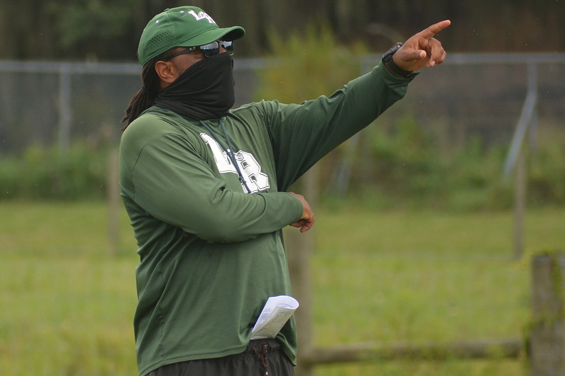 Rashad West gives orders underneath a mask at Lakewood Ranch High football practice. West said the Mustangs won&#39;t have the advantage of low expectations this season.