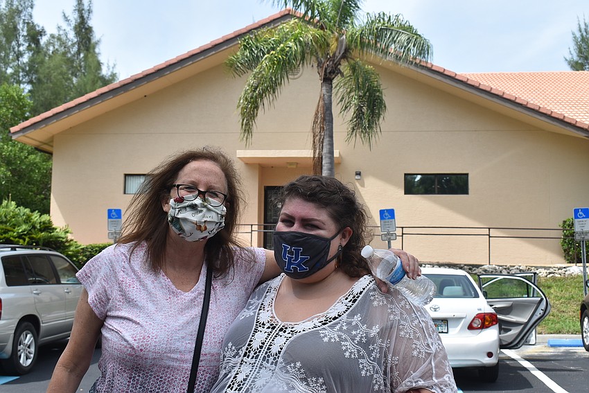 Robin Miller and Susie Davis help organize the meal pick-up.