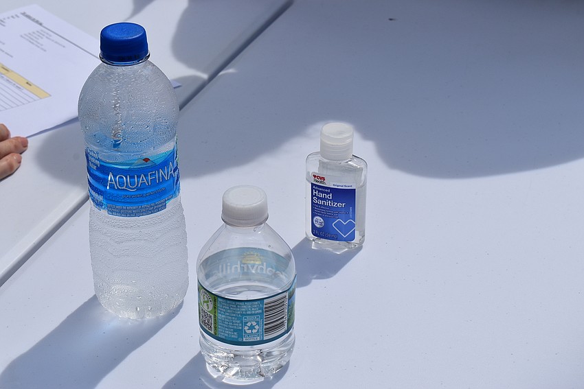Water and hand sanitizer — essentials of a hot summer day during a pandemic.