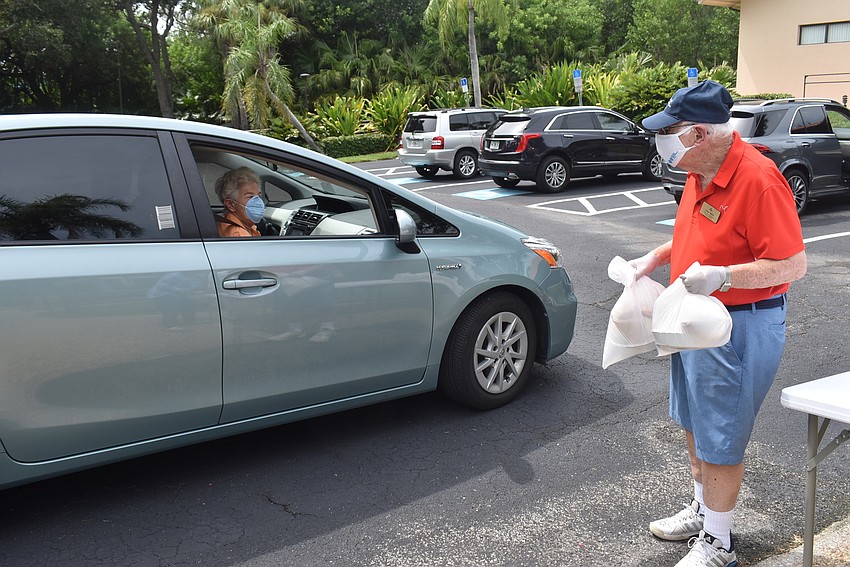 Lewis Moyer carries meals to a temple member.
