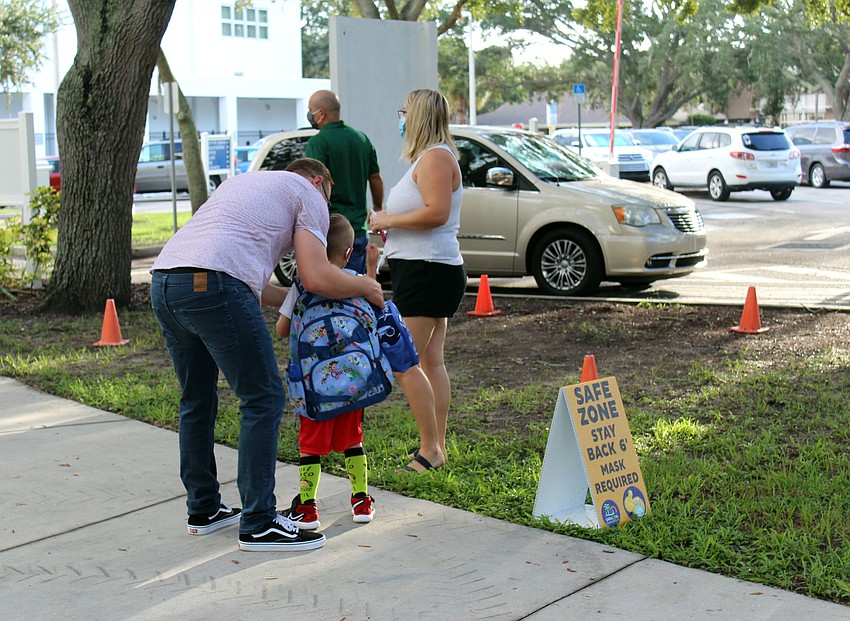 Parents hug their kids on the sidewalk before they walk into Southside Elementary School. Brynn Mechem