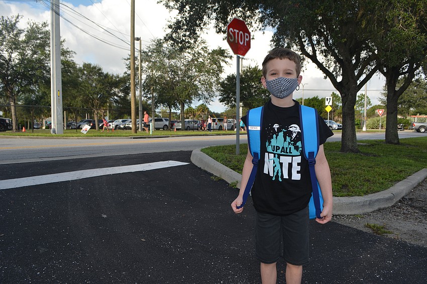 Aiden Hill stands outside Fruitville Elementary before heading in for the first day of the school year. David Conway