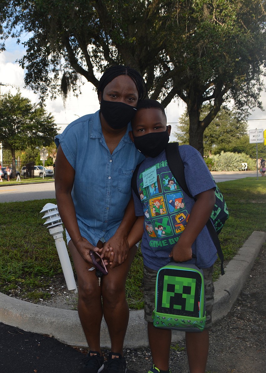 Tamieka Barracks brings Shammar Barracks to Fruitville Elementary for his first day of the school year. David Conway