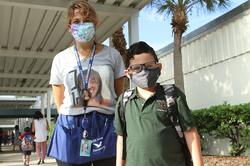 Kristen Crawford and Julien Vasquez, 5, walk into Alta Vista Elementary School.  Harry Sayer