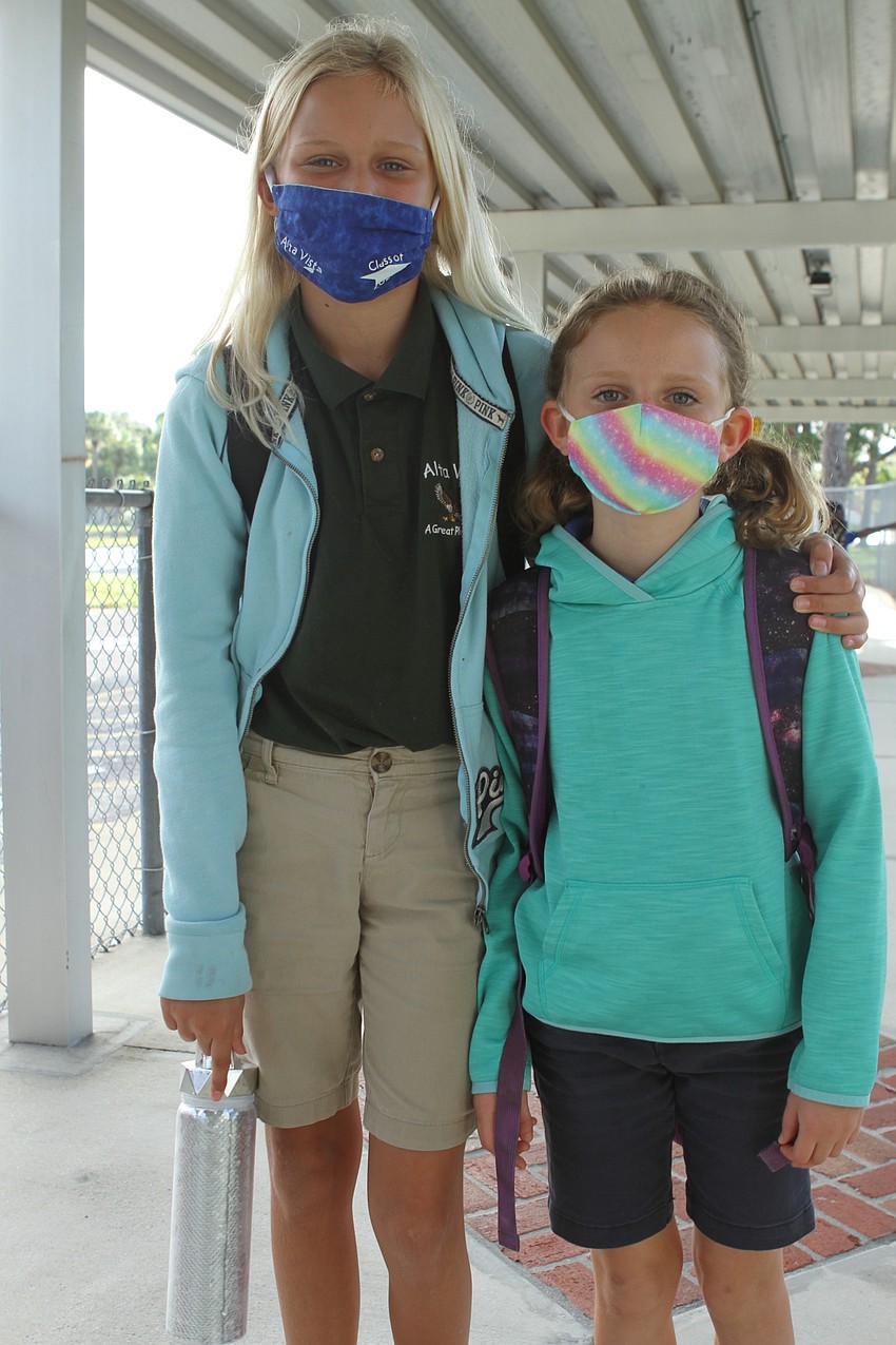 Ariel,10, and Seychelles Williamson, 8, are excited to start the day at Alta Vista Elementary School.  Harry Sayer