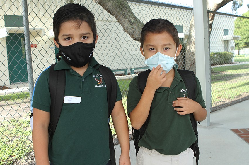 Thiago, 6, and Enzo Diaz, 5, prepare to enter Alta Vista Elementary School.  Harry Sayer