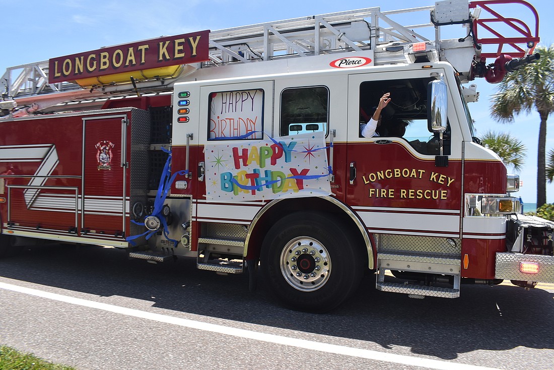 The truck is decorated with Happy Birthday or celebratory signs.