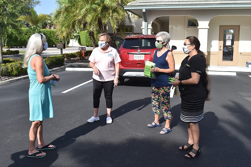 Karen Jennings, Gail Loefgren, Joyce Wartinbee and Debbie Shaffer chat in the parking lot.
