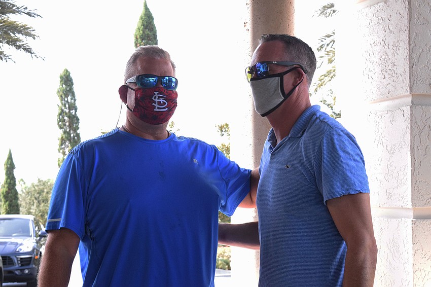 Gregory Rahn shares encouraging words with Jared Hermann during the drive thru fundraiser.