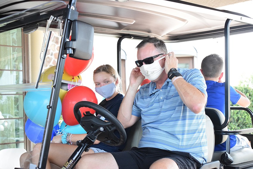 The Lake Club's Charley Hunn — with her father, Neil Hunn, and brother, Davis Hunn — brings balloons.