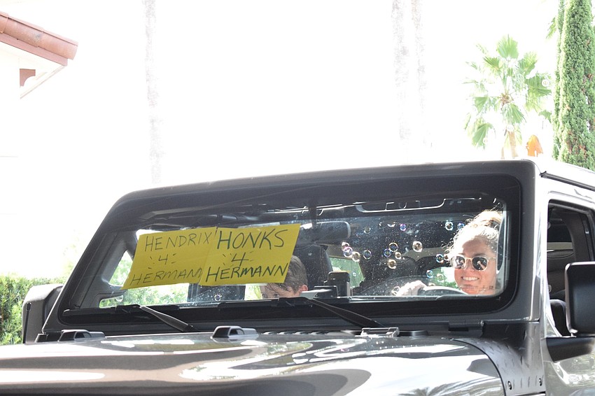 Julie Hendrix honks her horn as she goes through. fundraiser. She put signs on her car that said, 