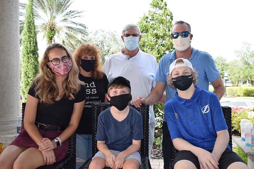 Janet Harmar, Willis Hermann, Jared Hermann (back), Makenna Hermann, Grayson Hermann and Weston Hermann (front) enjoy the drive thru fundraiser to raise money for pediatric cancer research.