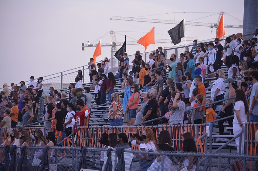The crowd at Sarasota High stands for the National Anthem. Sarasota County schools were allowed to have 25% capacity for their first home games.