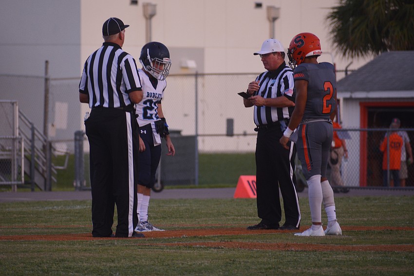 Sarasota senior Dominic Bennett, a captain, represents his team during the coin toss.