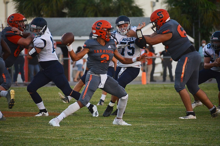 Sarasota quarterback Dominic Bennett fires a pass to his right.