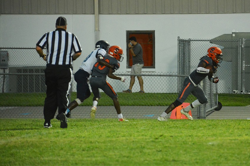 Sarasota senior defensive back Terrell Pack (right) intercepts a North Port pass in the end zone.