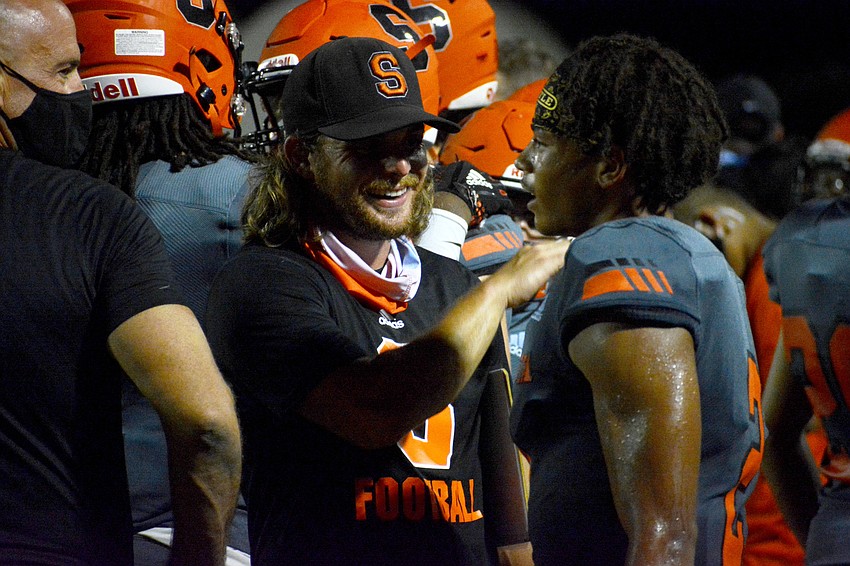 Brody Wiseman congratulates quarterback Dominic Bennett on a job well done. Bennett accounted for five touchdowns against North Port.