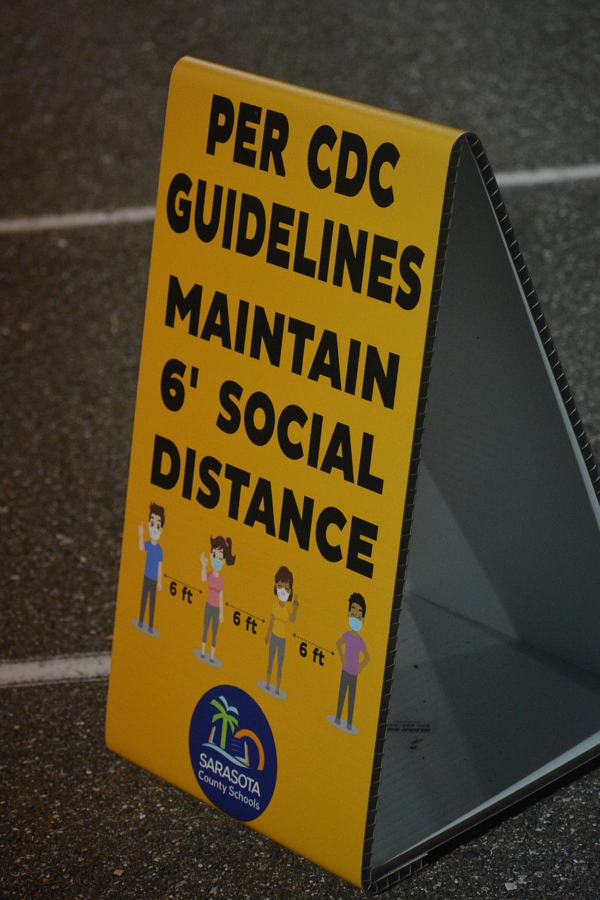 Signs like this one were placed throughout the stadium, reminding fans to social distance and wear their masks.