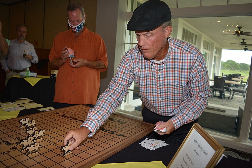 Sarasota's Dave Ruth acts as dealer for an across-the-board horse racing game guests enjoyed.
