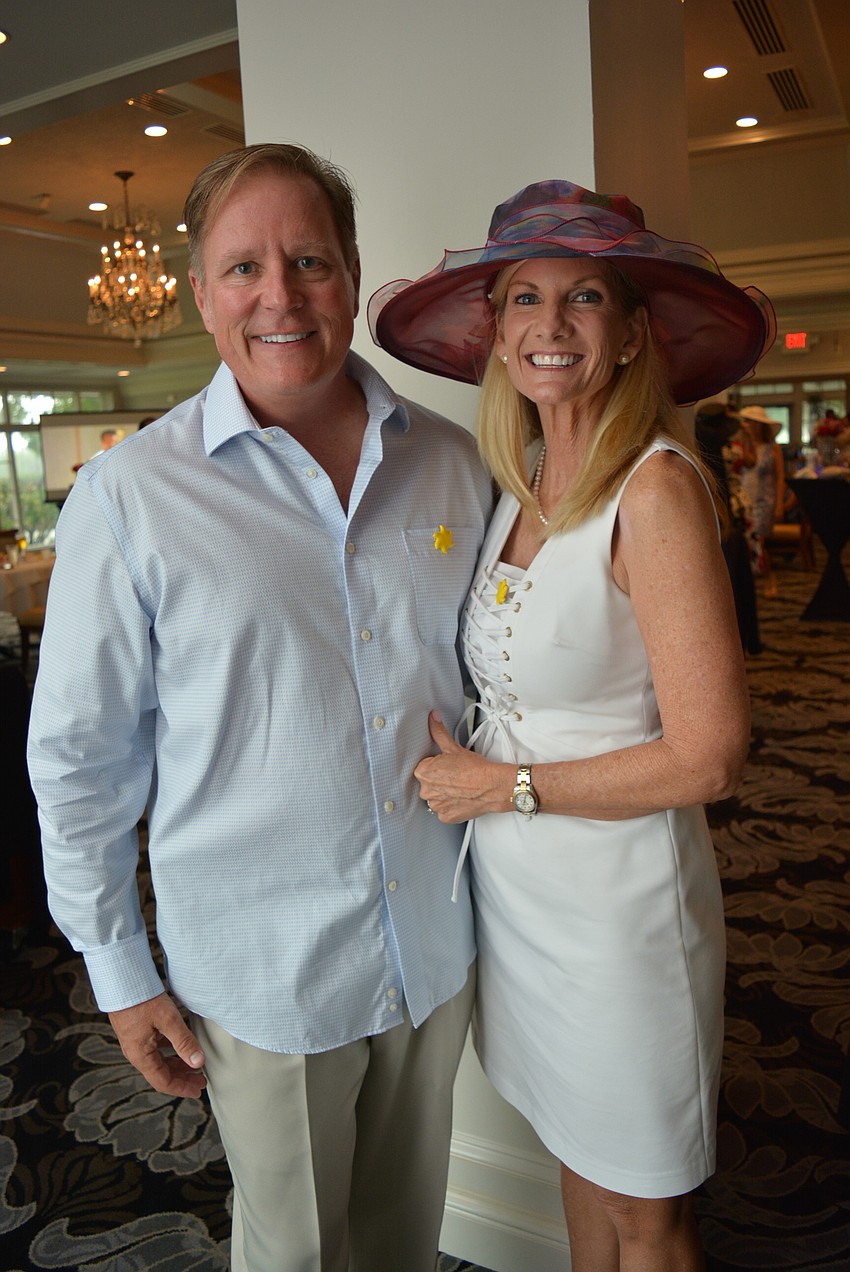 Sarasota's Brian and Teri Sayre had fun watching others play a board horse racing game.